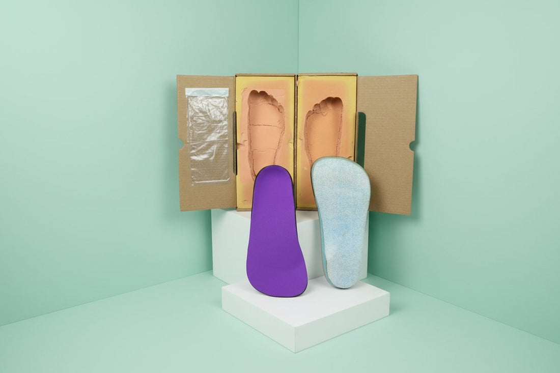 CustomTread orthotic insoles in blue tones placed on a clean surface, product photography