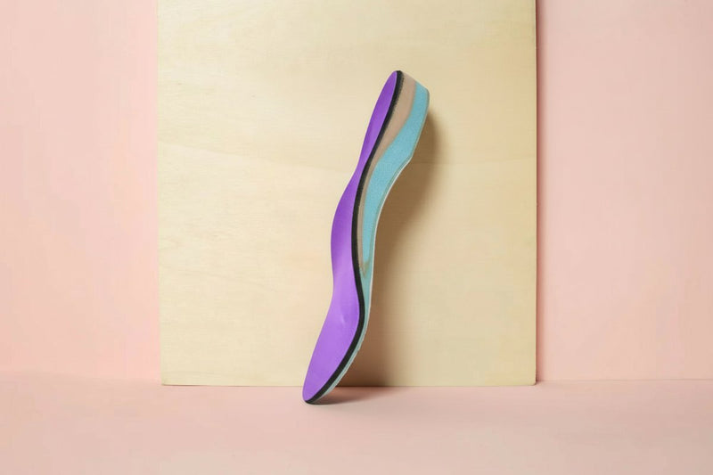 CustomTread orthotic insoles on a white surface showing arch support structure, custom orthotics for running